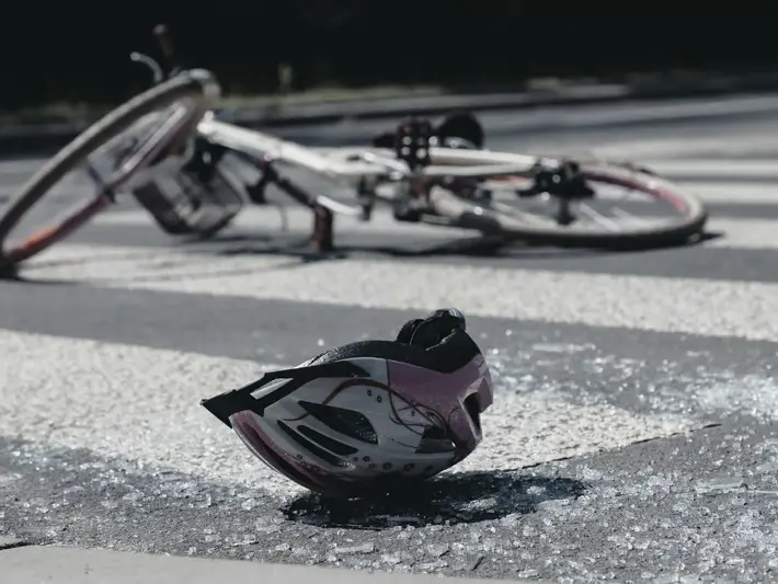 Goodyear illegal left turn accident attorney reviewing crash scene evidence near Palm Valley neighborhood entrance